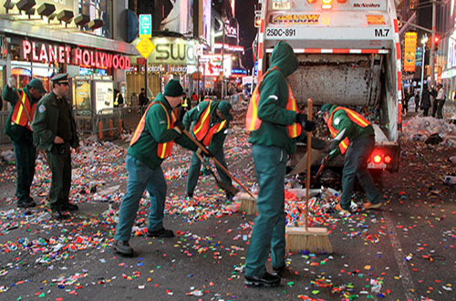 sanitation workers cleaning the road