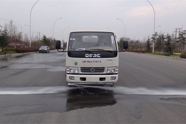 water truck flushing the mud on road