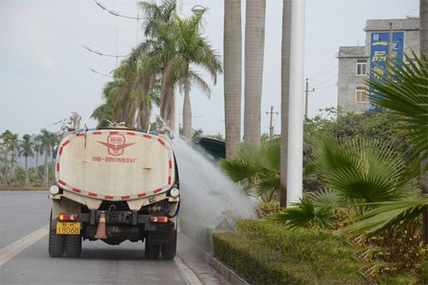 water truck watering the tree and green belt